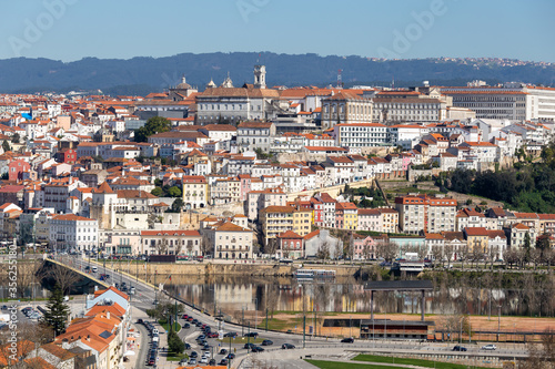 historic Coimbra cityscape with university at top of the hill in the evening, Portugal © Angelino