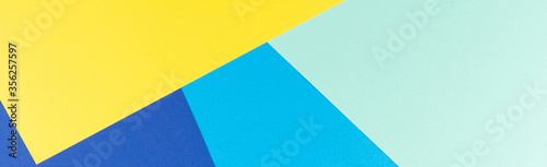 Color papers geometry flat composition background with yellow and blue tones