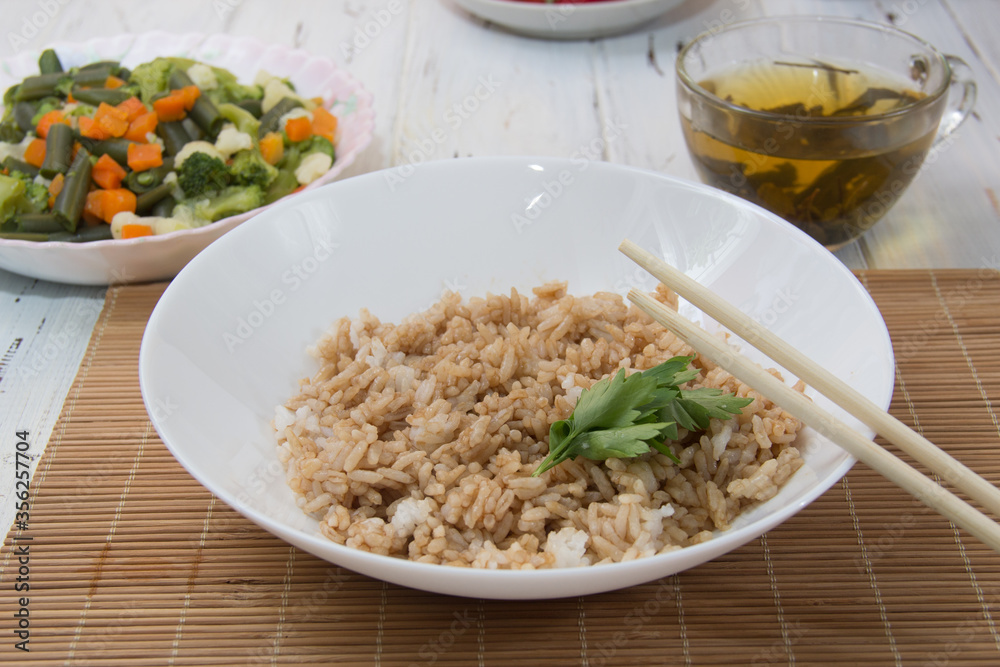 Rice with soy sauce and boiled vegetables close-up on a decorative background. Rice Dish. Fried mushrooms. Healthy eating Vegetarian food. Vegetarian dish Rice with soy sauce and boiled vegetables close-up on a decorative background. Rice Dish. Fried mushrooms. Healthy eating Vegetarian food. Vegetarian dish