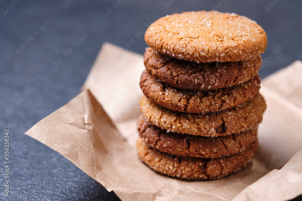 Tower of oatmeal cookies with honey. Dessert on brown paper, on the table close-up. Tower of oatmeal cookies with honey. Dessert on brown paper, on the table close-up.