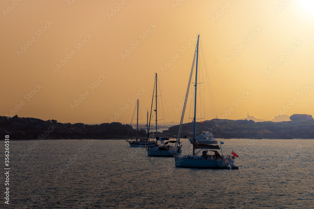 sailing yachts at sunset
