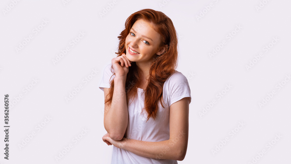 Cute Red-Haired Teen Girl Posing Smiling To Camera, White Background Cute Red-Haired Teen Girl Posing Smiling To Camera, White Background