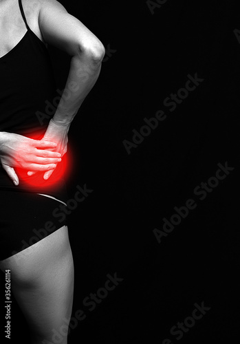 Woman pain back. Pain. Dark background. Woman back. 