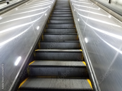 tall escalator with lights