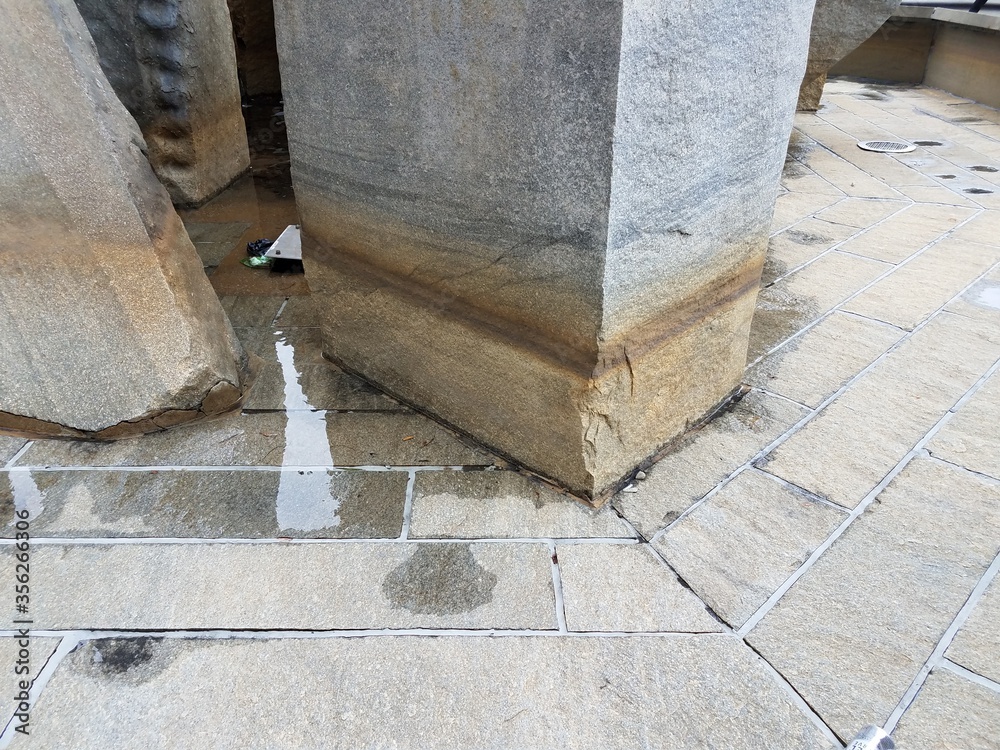 dry water fountain with stone blocks and water line