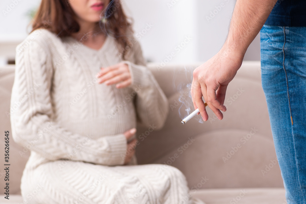 Man and pregnant woman in antismoking concept Man and pregnant woman in antismoking concept