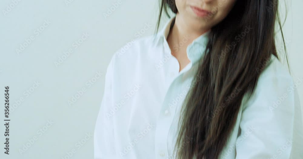 Woman sitting on bed with phone and notebook Woman sitting on bed with phone and notebook