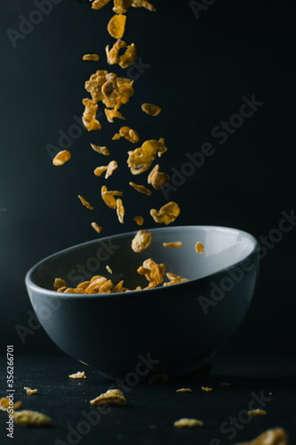 cornflakes dalling into a bowl 