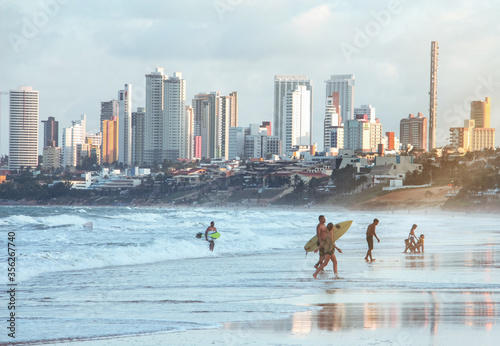 Beautiful beach scenery with surfers ready to hit the waves photo