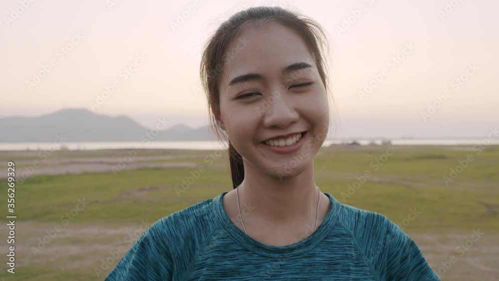 Happy Asian girl smile on the face enjoying nature looking to camera Happy Asian girl smile on the face enjoying nature looking to camera