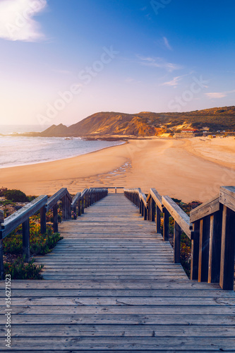 Wooden walkway to the beach Praia da Amoreira  District Aljezur  Algarve Portugal. Panorama from Amoreira beach in the Algarve Portugal. Beach and estuary of the Aljezur river  Praia da Amoreira.