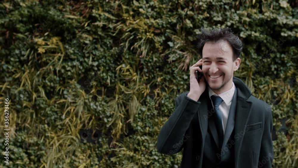Smiling businessman having a phone call outdoors Smiling businessman having a phone call outdoors