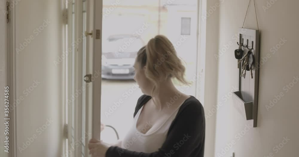 New parents arriving at home with their newborn baby girl. New parents arriving at home with their newborn baby girl.