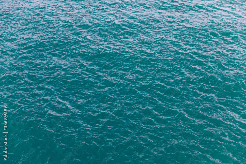 Background shot of aqua sea water surface. Sea surface aerial view. Waving water surface of the sea background. Background shot of aqua sea water surface. Sea surface aerial view. Waving water surface of the sea background.