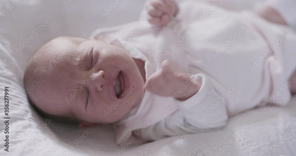 High angle close up of crying newborn baby girl. High angle close up of crying newborn baby girl.