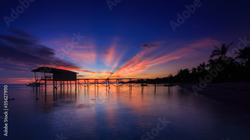 Wallpaper Mural Amazing beautiful sunset with silhouette wooden jetty and coconut tree Torontodigital.ca