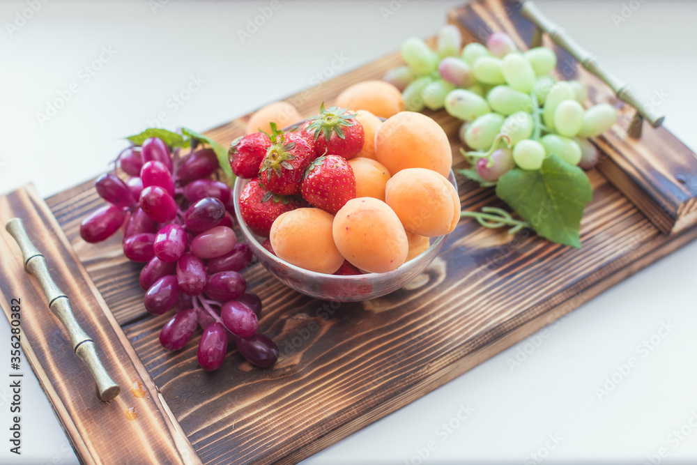 Various fresh summer berries - strawberry, grape and apricot. Reusable bag with berry. Tote bag, minimal waste. Top view Various fresh summer berries - strawberry, grape and apricot. Reusable bag with berry. Tote bag, minimal waste. Top view