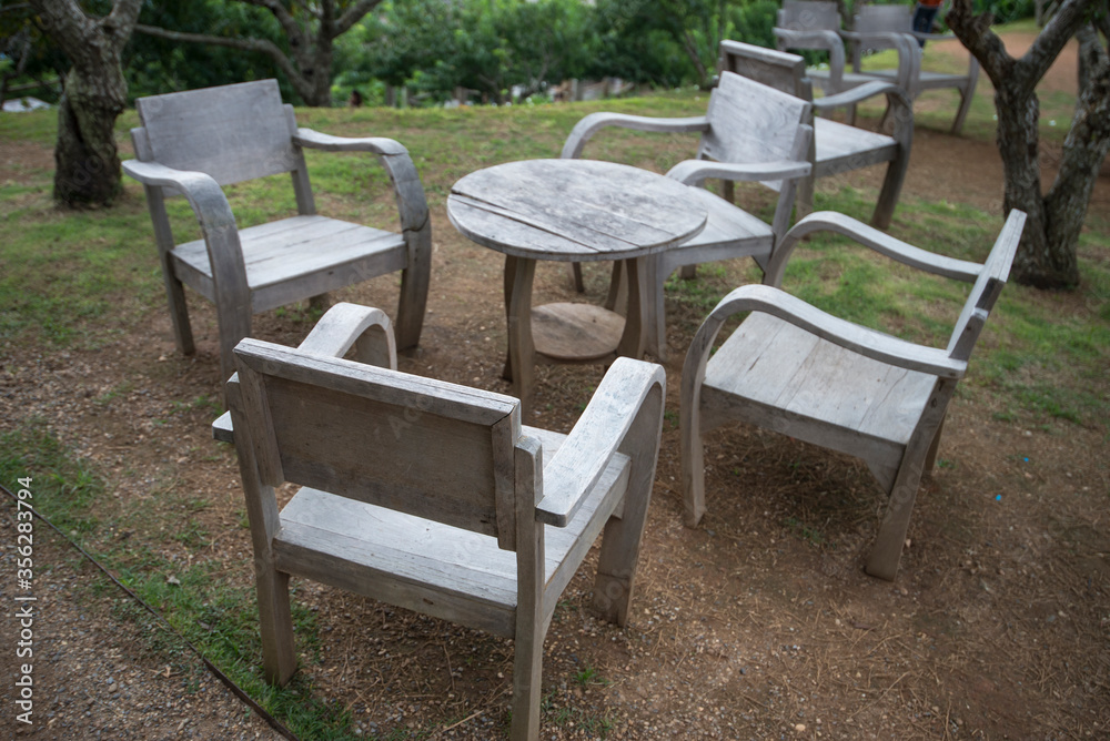 Wooden table and chairs in a garden Wooden table and chairs in a garden