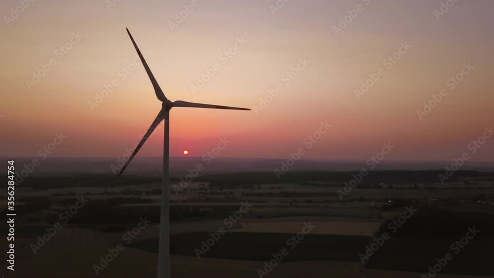 Wind turbine in agricultural landscape at sunset in Rhineland-Palatine, Germany. Wind turbine in agricultural landscape at sunset in Rhineland-Palatine, Germany.