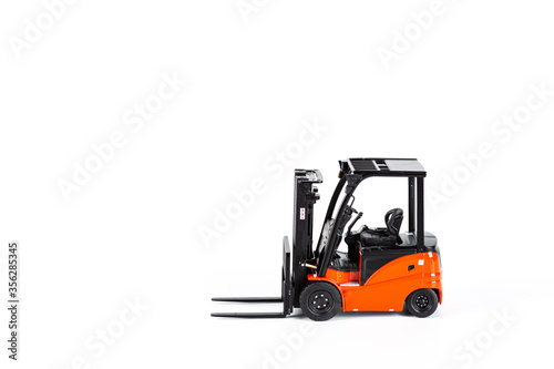 Red toy forklift loader isolated on white background. Copy Space for text. moving service and distribution products. Delivery production. Logistics and industrial concept.