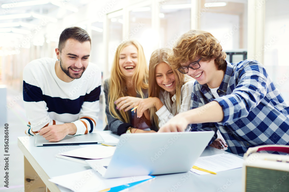 Smiling handsome young international students resting after lesson 