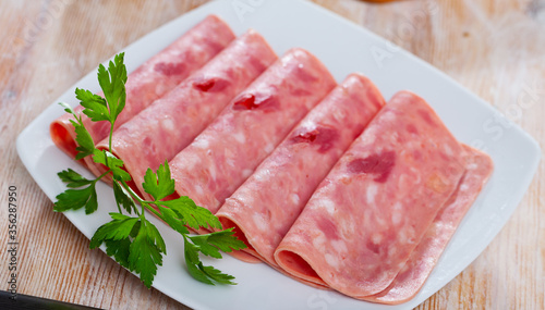 Sliced ham on wooden background