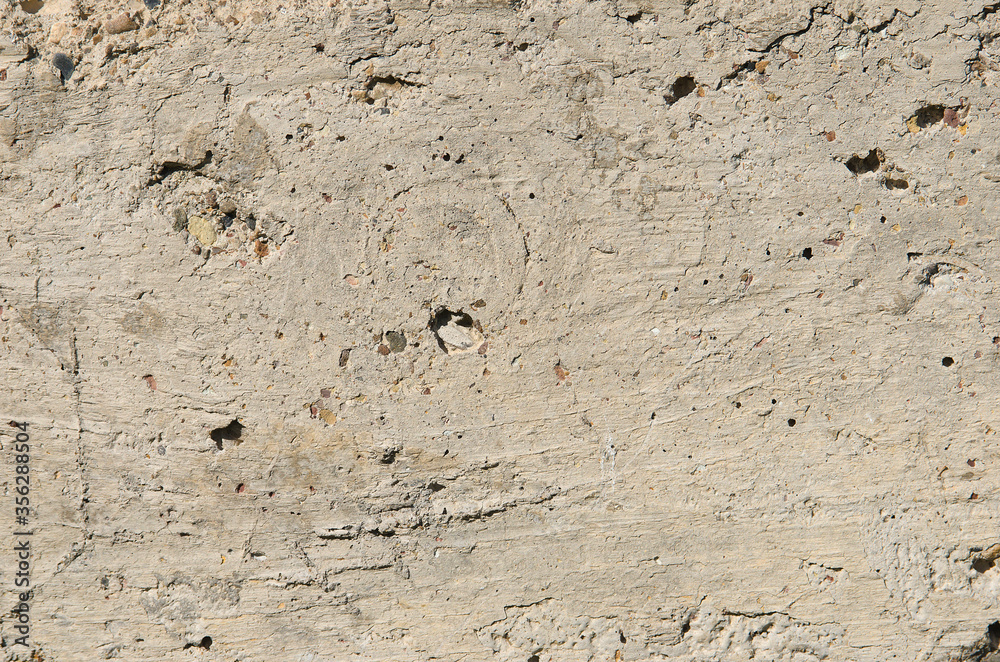 The texture of the wall is cement mixed with small stones. The texture of the wall is cement mixed with small stones.