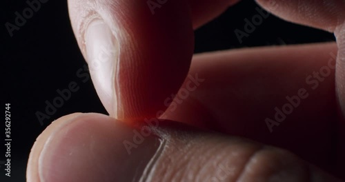 Extreme Closeup of index finger scratching thumbnail in a nervous manner being pressed