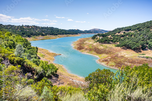 High angle view of Anderson Reservoir, a man made lake in Morgan Hill, managed by the Santa Clara Valley Water District, maintained at low level due to failure risk in case of earthquake; California