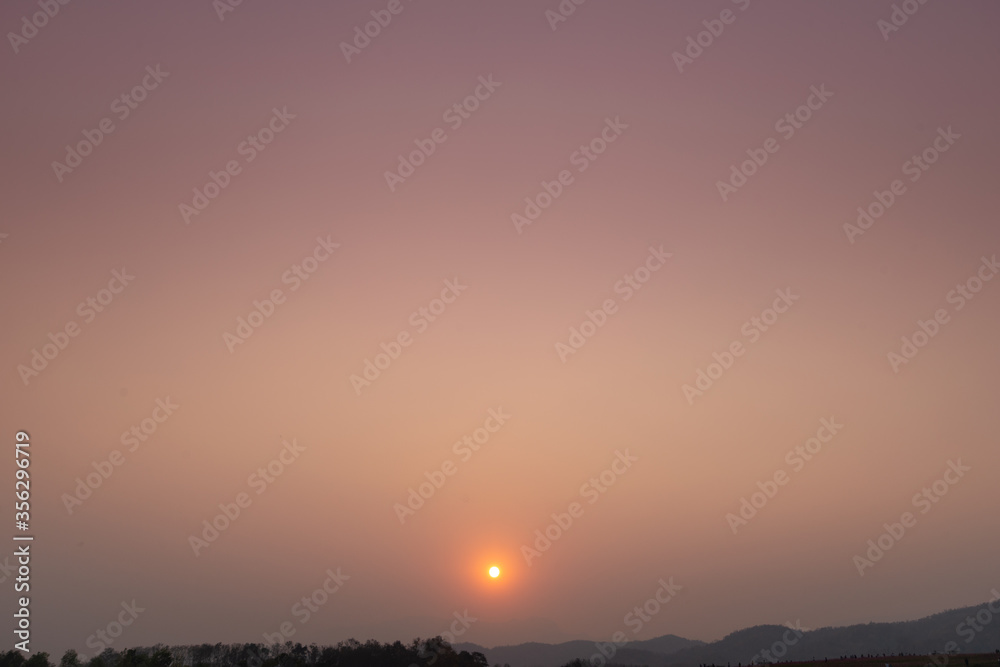 Nature view. Yellow Sunset Background and silhouette mountain.