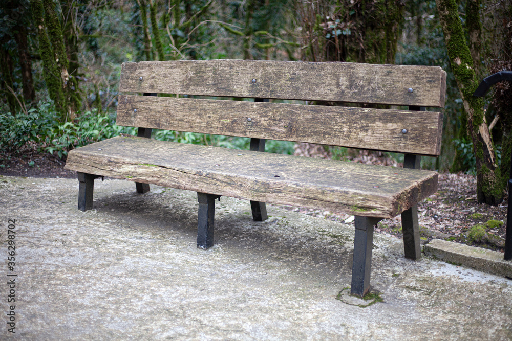 A bench made of wood in the park.
