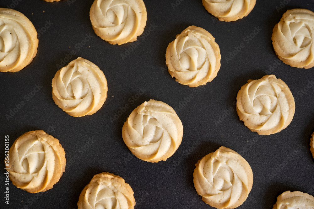 Butter cookies arrange in row in baking tray Butter cookies arrange in row in baking tray