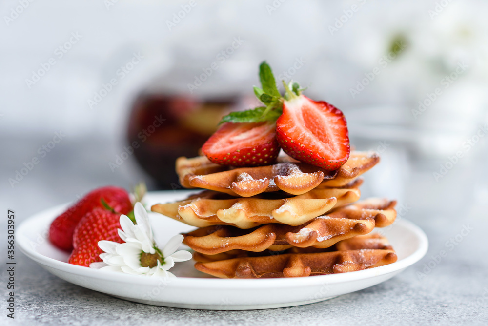Delicious fresh baked belgian waffles with berries and fruit Delicious fresh baked belgian waffles with berries and fruit