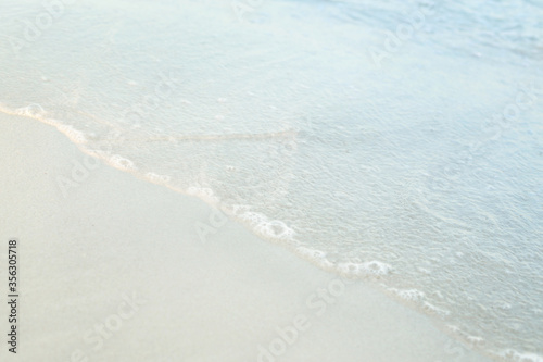 Soft focus and tone of wave sea on the sandy beach.Summer vacation background.