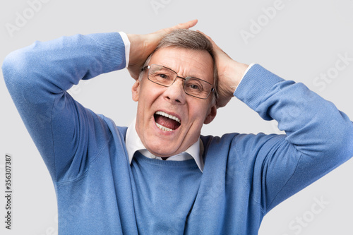 Wallpaper Mural Emotional Senior Man Shouting Touching Head Posing On Gray Background Torontodigital.ca