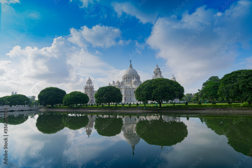 Victoria Memorial, Kolkata , Calcutta, West Bengal, India with blue sky and reflection on water. A very famous Historical Monument of Indian architecture.