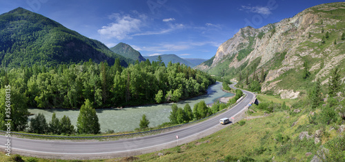 Summer panoramic view. Asphalt road passes through the gorge along the river, Chuiski tract, Altay. Travels in Russia. photo