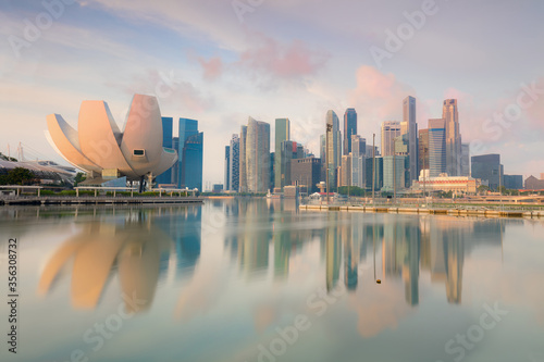 Popular view of Singapore cityscape at early morning with real reflections on sea water