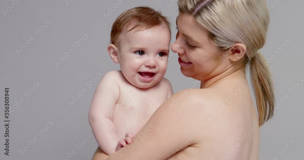 SLO MO MS Young mother hugging and kissing baby son (6-11 months) SLO MO MS Young mother hugging and kissing baby son (6-11 months)