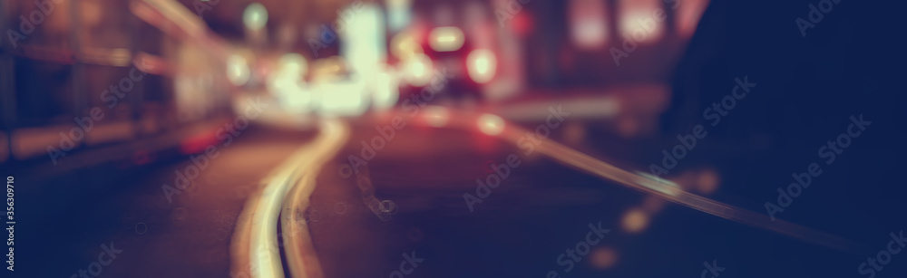 view of car in traffic jam / rear view of the landscape from window in car, road with cars, lights and the legs of the cars night view view of car in traffic jam / rear view of the landscape from window in car, road with cars, lights and the legs of the cars night view