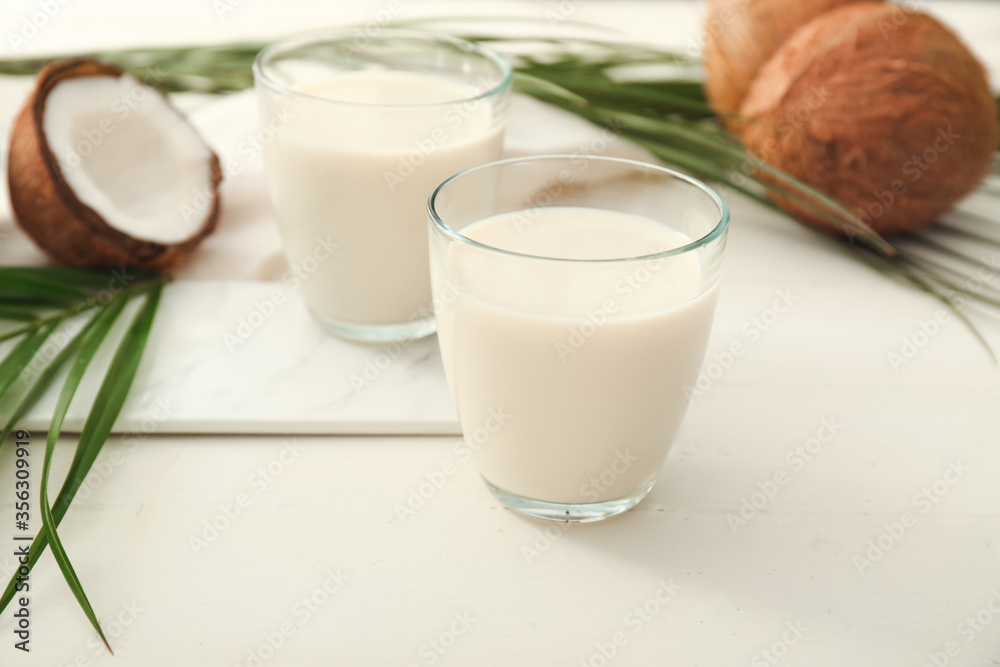 Glasses of tasty coconut milk on white background Glasses of tasty coconut milk on white background