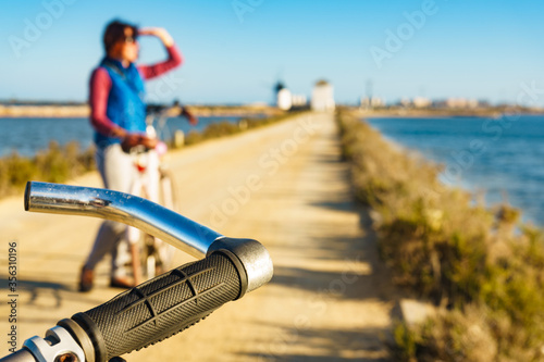 Woman with bike at San Pedro del Pinatar park, Spain photo