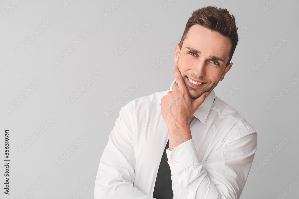 Portrait of handsome businessman on grey background Portrait of handsome businessman on grey background