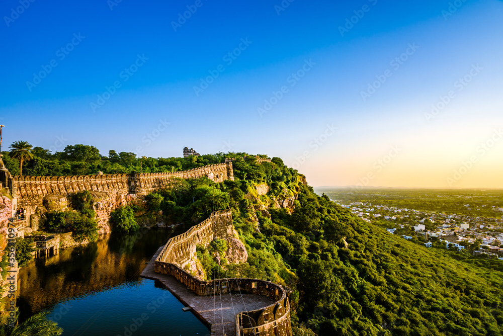 View during sunset from Chittor or Chittorgarh Fort with city in backdrop. It is one of the largest forts in India &  listed in the UNESCO World Heritage Sites list as Hill Forts of Rajasthan.
