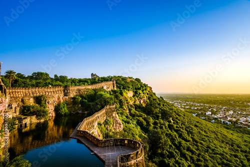 View during sunset from Chittor or Chittorgarh Fort with city in backdrop. It is one of the largest forts in India & listed in the UNESCO World Heritage Sites list as Hill Forts of Rajasthan. 