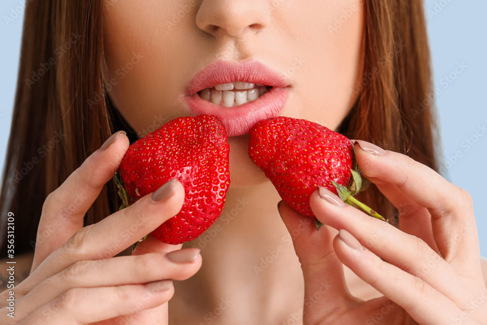 Sexy young woman with strawberry on color background, closeup Sexy young woman with strawberry on color background, closeup