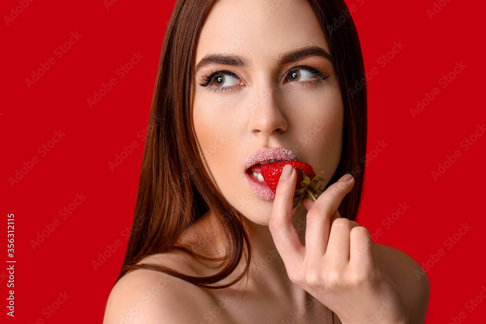 Sexy young woman with strawberry on color background Sexy young woman with strawberry on color background