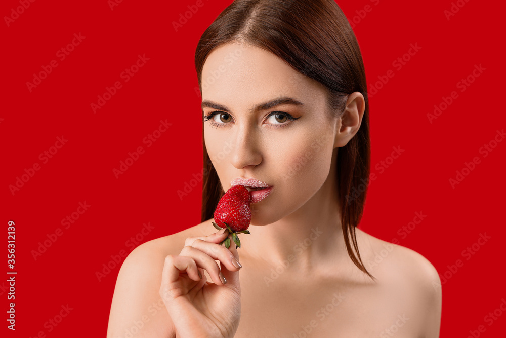 Sexy young woman with strawberry on color background Sexy young woman with strawberry on color background