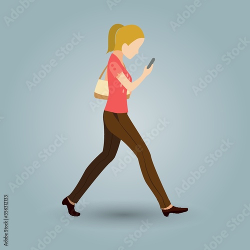 woman walking and looking at phone