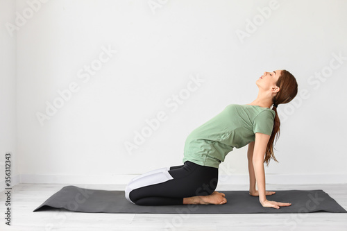 Young pregnant woman practicing yoga in gym © Pixel-Shot